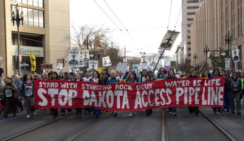 Protesters carrying a banner saying Stop Dakota Access Pipeline