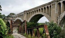 Two bridges, one concrete and one iron, in disrepair