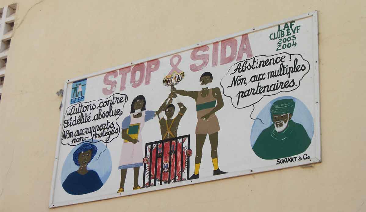 Photo of a painted wall mural in Senegal saying "Stop SIDA"