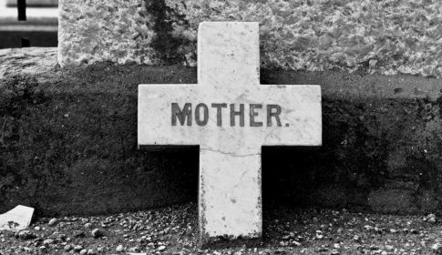Old gravestone cross with the inscription Mother.