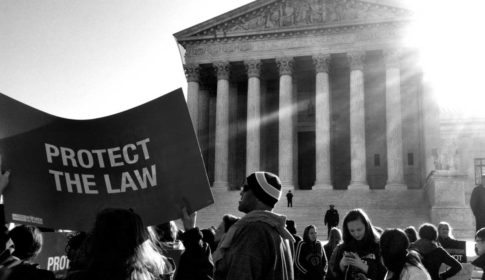 Protesters with sign saying Protect the Law outside the US Supreme Court