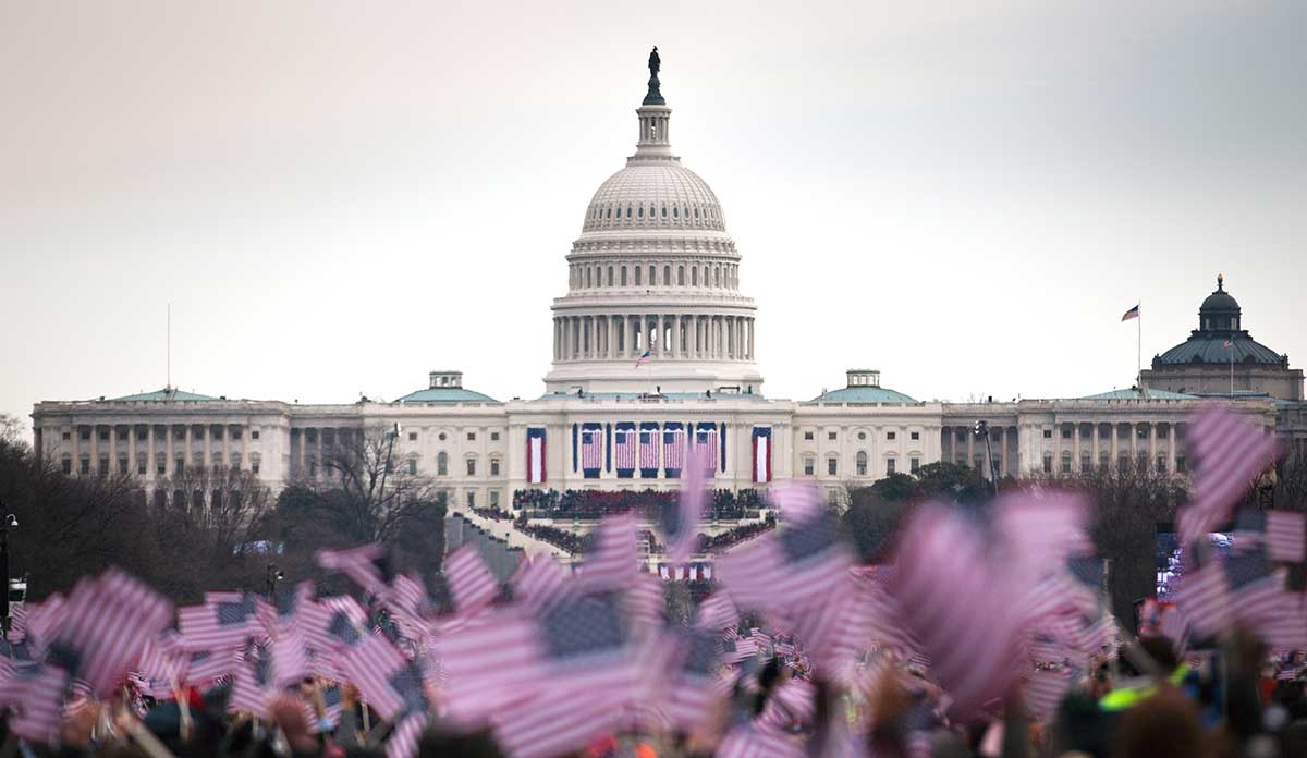 Crowd waving US flags in front of the US Capitol building at Obama inauguration