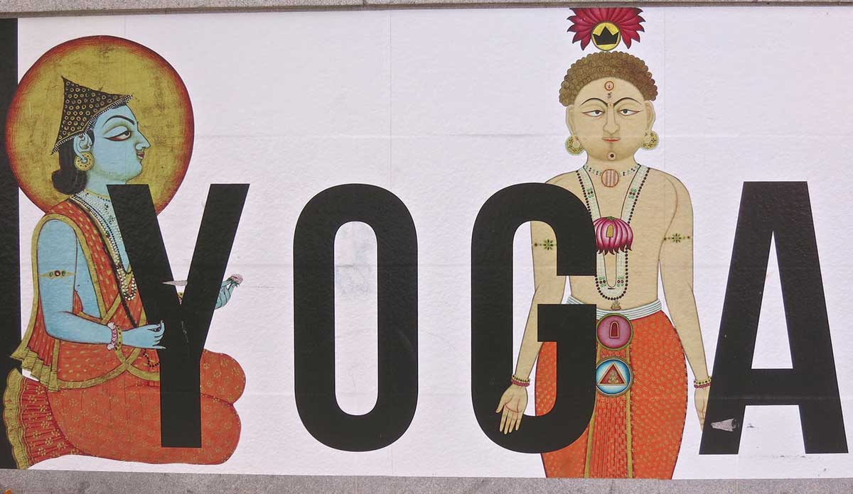 Painted mural with figures and the word YOGA