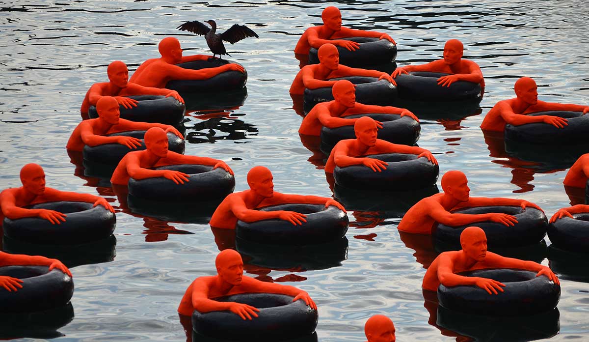 (SOS) Safety Orange Swimmers, a floating public art installation in Fort Point Channel, Boston