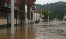 A street with floodwaters covering the sidewalks