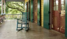 An empty rocking chair on a large porch