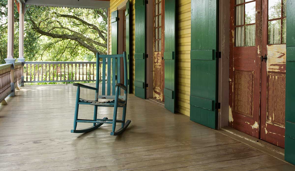 An empty rocking chair on a large porch