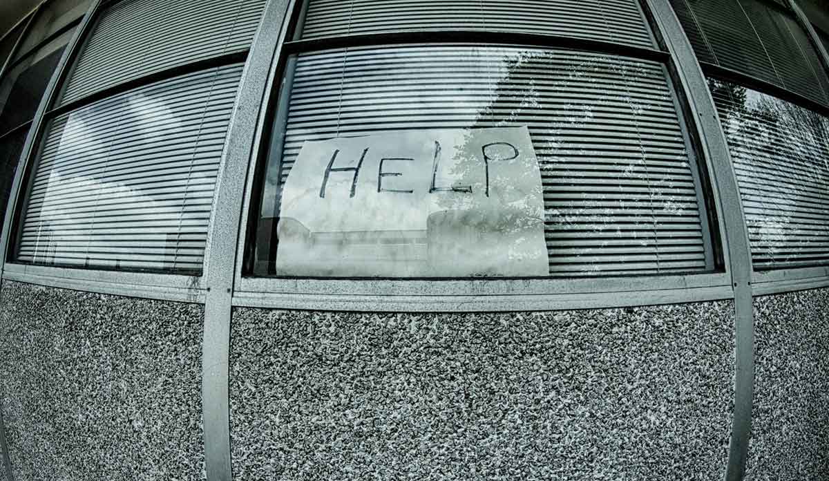 A fisheye lens view of a window with a handwritten sign saying HELP