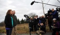 Maine nurse Kaci Hickox standing in front of a large group of journalists