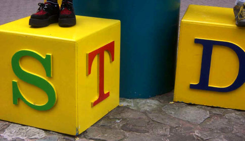 Two large yellow blocks with the letters S, T, and D painted on them