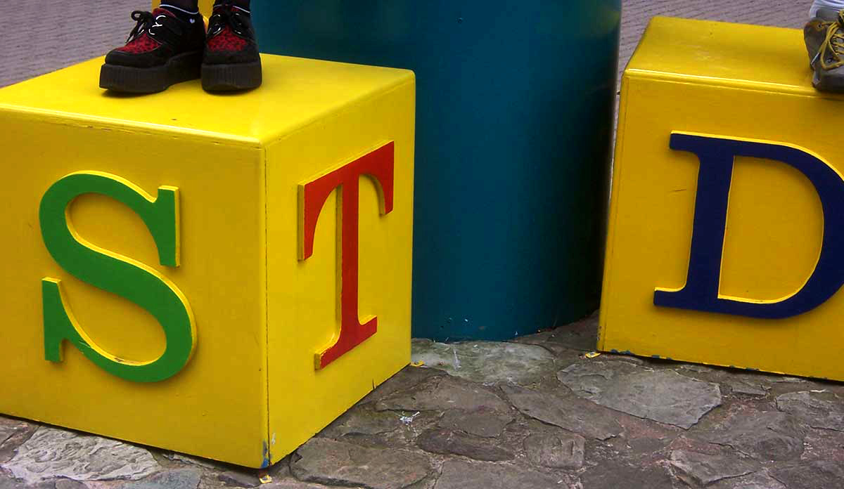 Two large yellow blocks with the letters S, T, and D painted on them