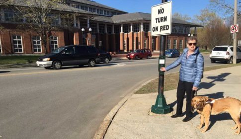 Jini Fairley at a crosswalk, with her service dog