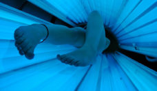 View of a persons legs inside a tanning bed
