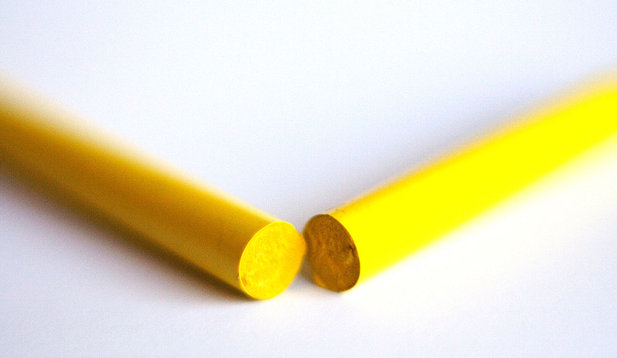 A yellow crayon broken in two pieces