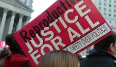 Protesters with sign saying Reproductive Justice For all, Safety over Politics