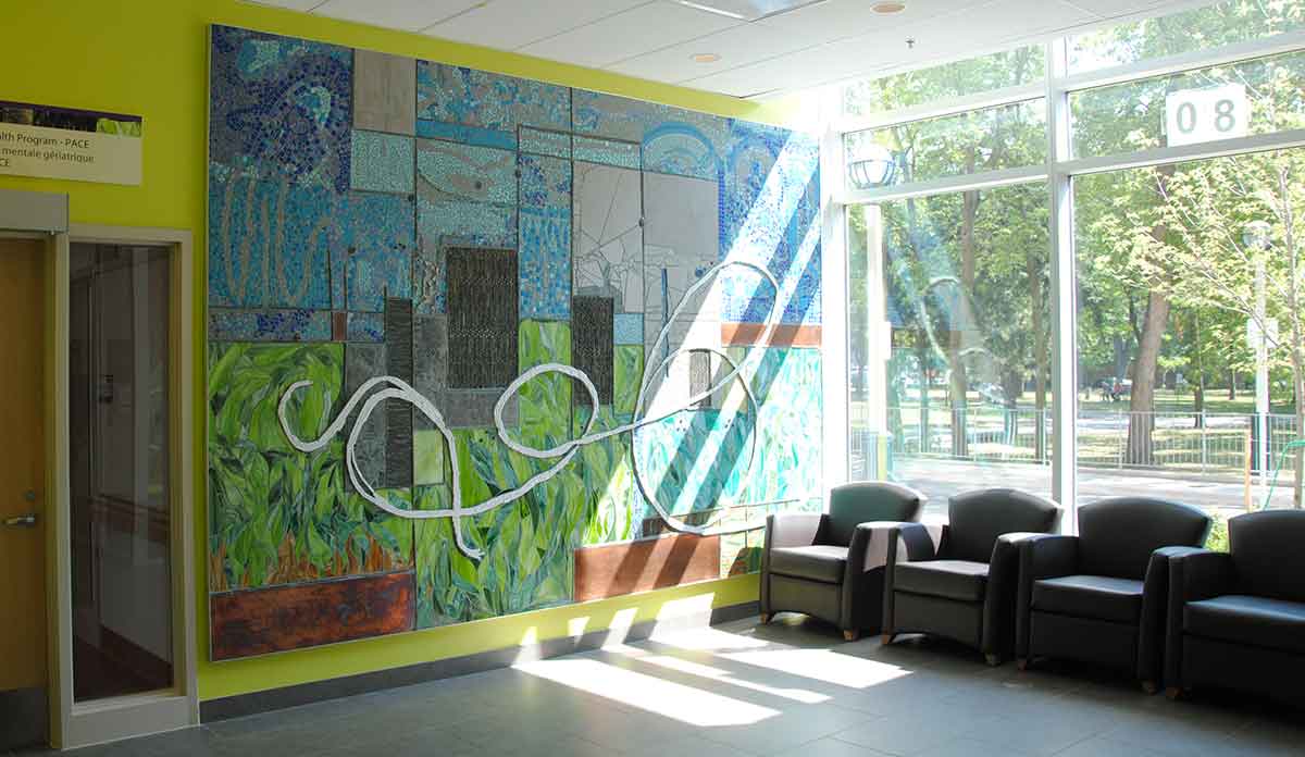 A waiting room with a mural in a hospital