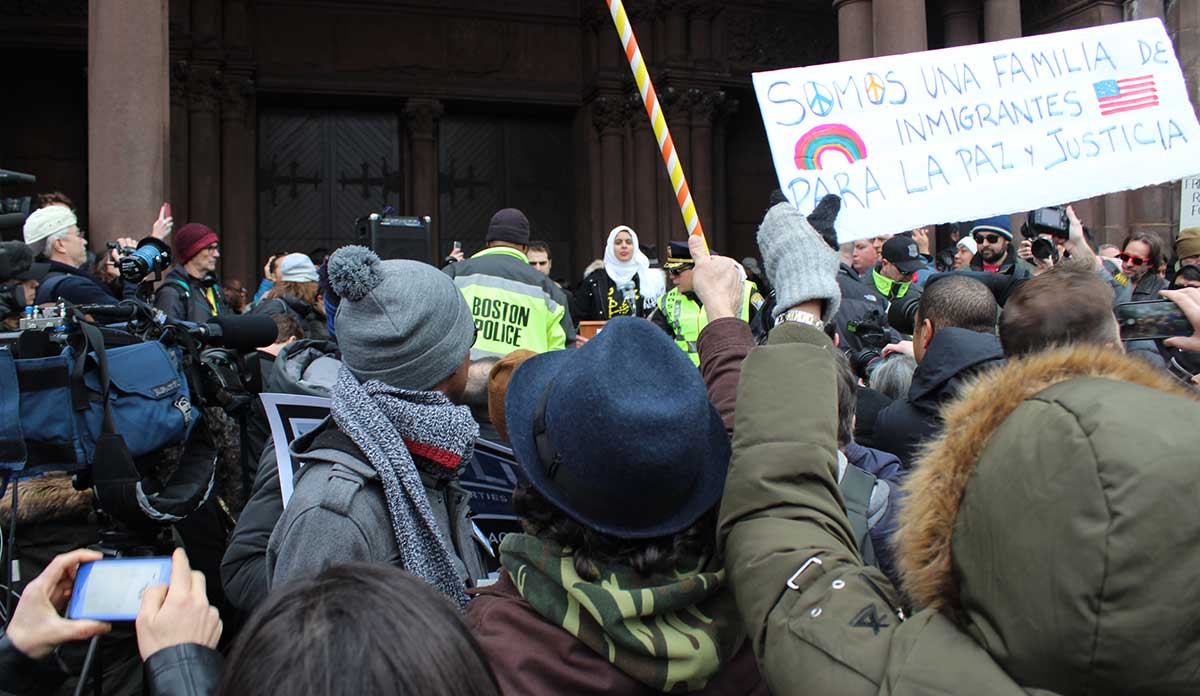Women holds sign at Boston rally against Trump Muslim Ban 1.0. Photo © Gilbert Benavidez.