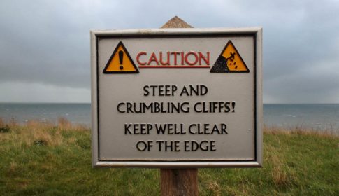 Caution sign: steep and crumbling cliff