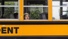 Boy looking out of the window of a schoolbus