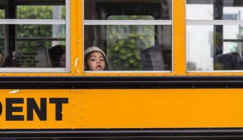 Boy looking out of the window of a schoolbus