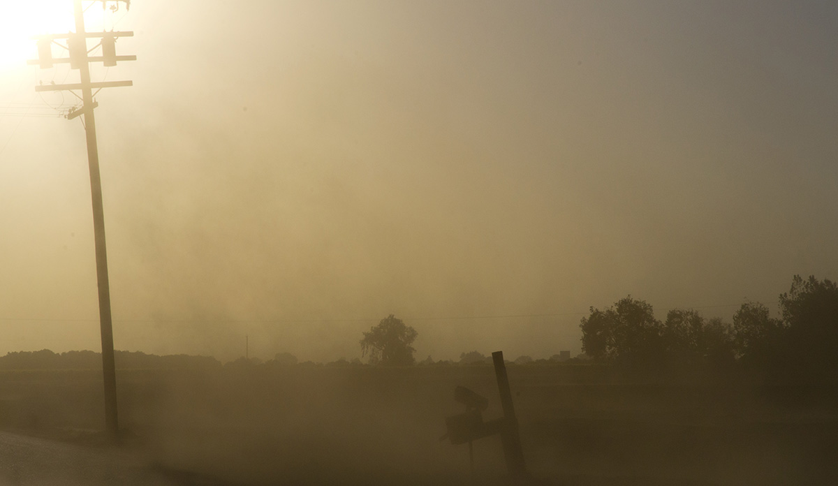 Landscape with dust in the air obscuring the sun during California drought