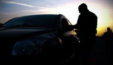 Policeman with a car at a DUI checkpoint at sunset