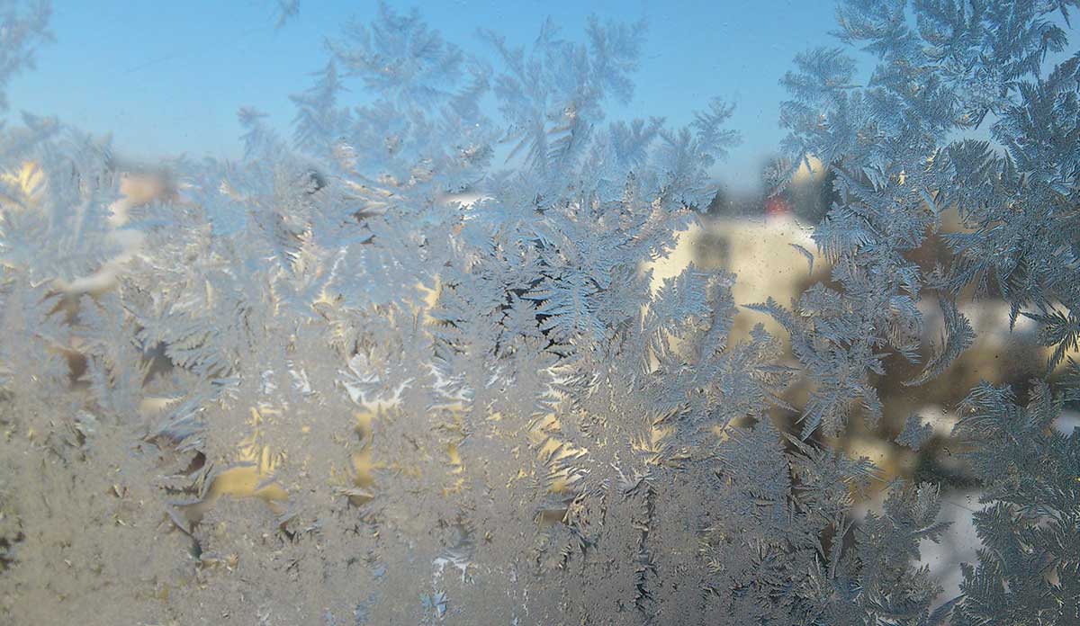 Frost on a window pane obscuring the view outside