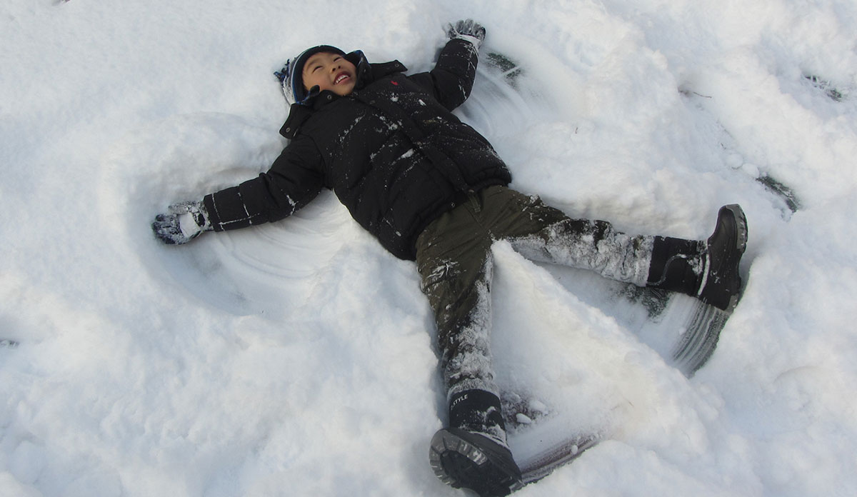 Child making a snow angel