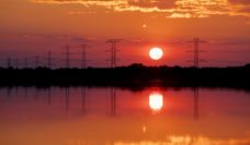 Floodwaters and electric poles at sunset after Hurricane Harvey
