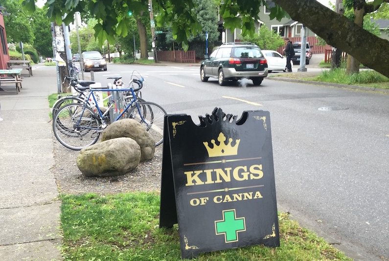 Marijuana advertising on a sandwich board in a neighborhood