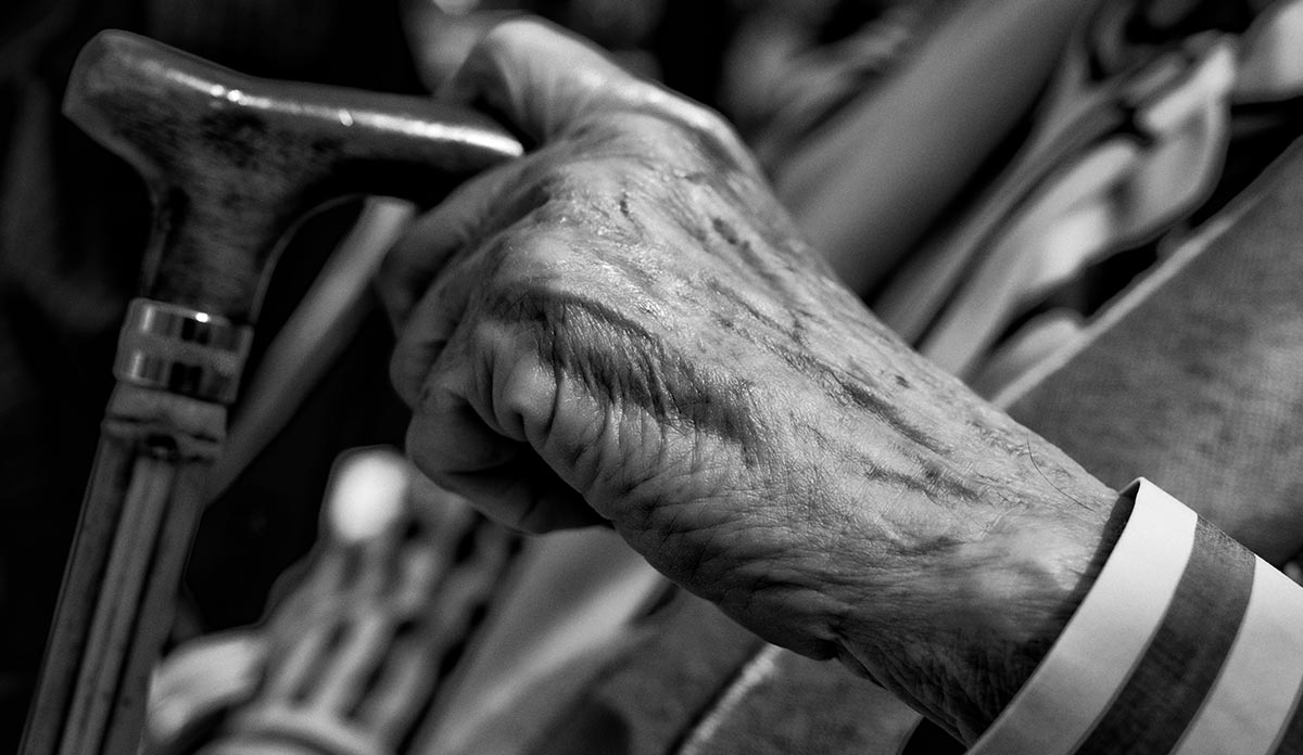 Elderly-man-holding-a-walking-stick