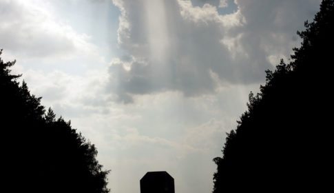 Gravestone with light coming from the clouds