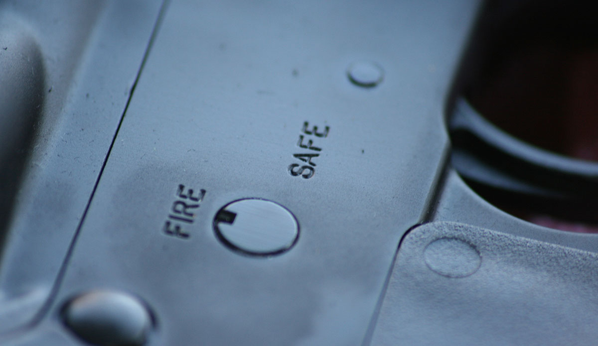 Close-up of safety on a gun with the words Fire and Safe