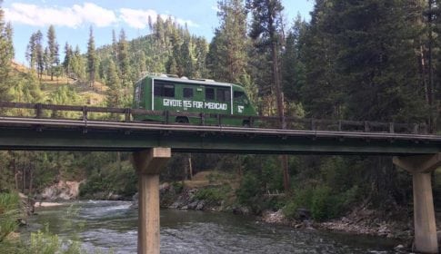 Medicaid for Idaho van on a high bridge spanning a river