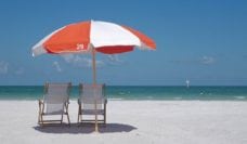 An umbrella and two chairs on a beautiful beach