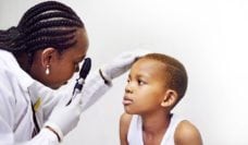 Doctor examining a boy's eyes