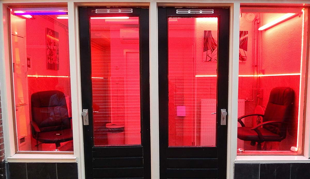 Two empty chairs in a window in Amsterdam red light district