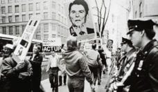 New York, NY: May 5, 1988. Watched by a line of police, ACT UP stages a demonstration. © Lee Snider/The Image Works