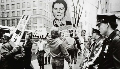 New York, NY: May 5, 1988. Watched by a line of police, ACT UP stages a demonstration. © Lee Snider/The Image Works