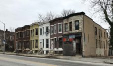 Rowhouses with broken and boarded up windows in Baltimore