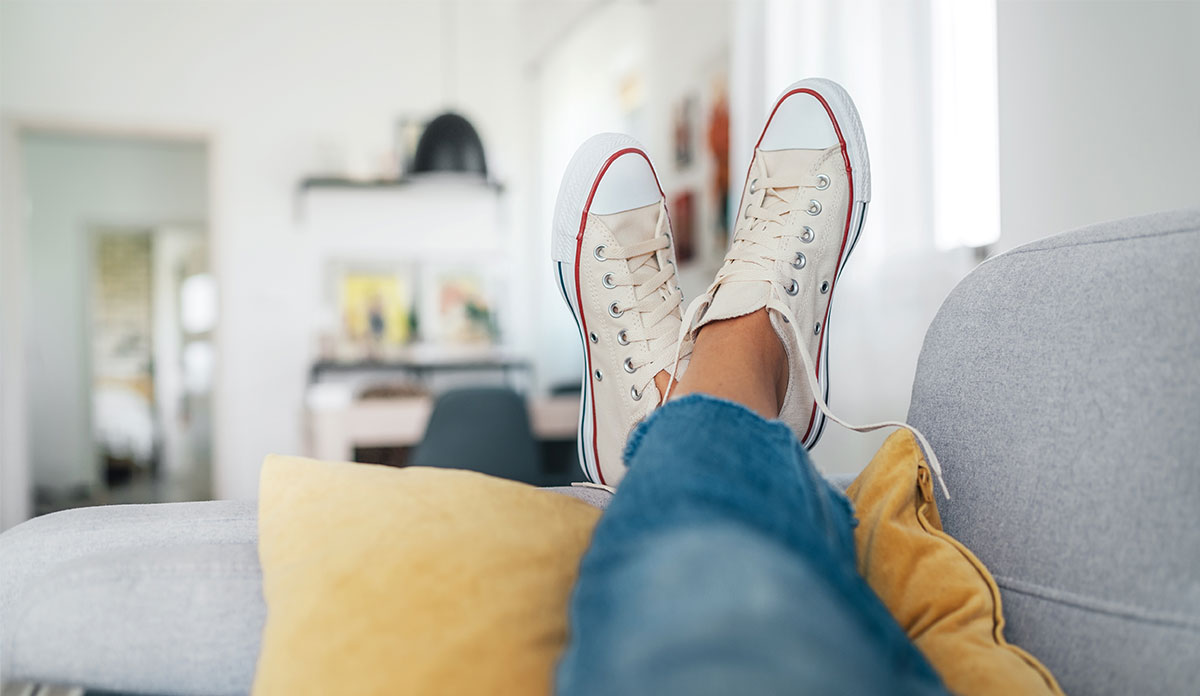 feet of person relaxing on couch