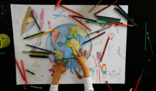 child drawing the earth