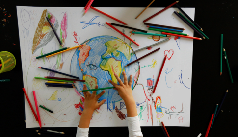 child drawing the earth