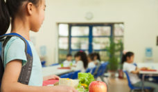 girl holding lunch tray