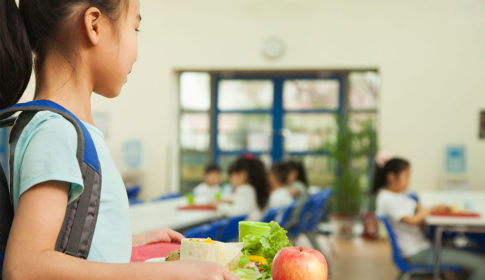 girl holding lunch tray