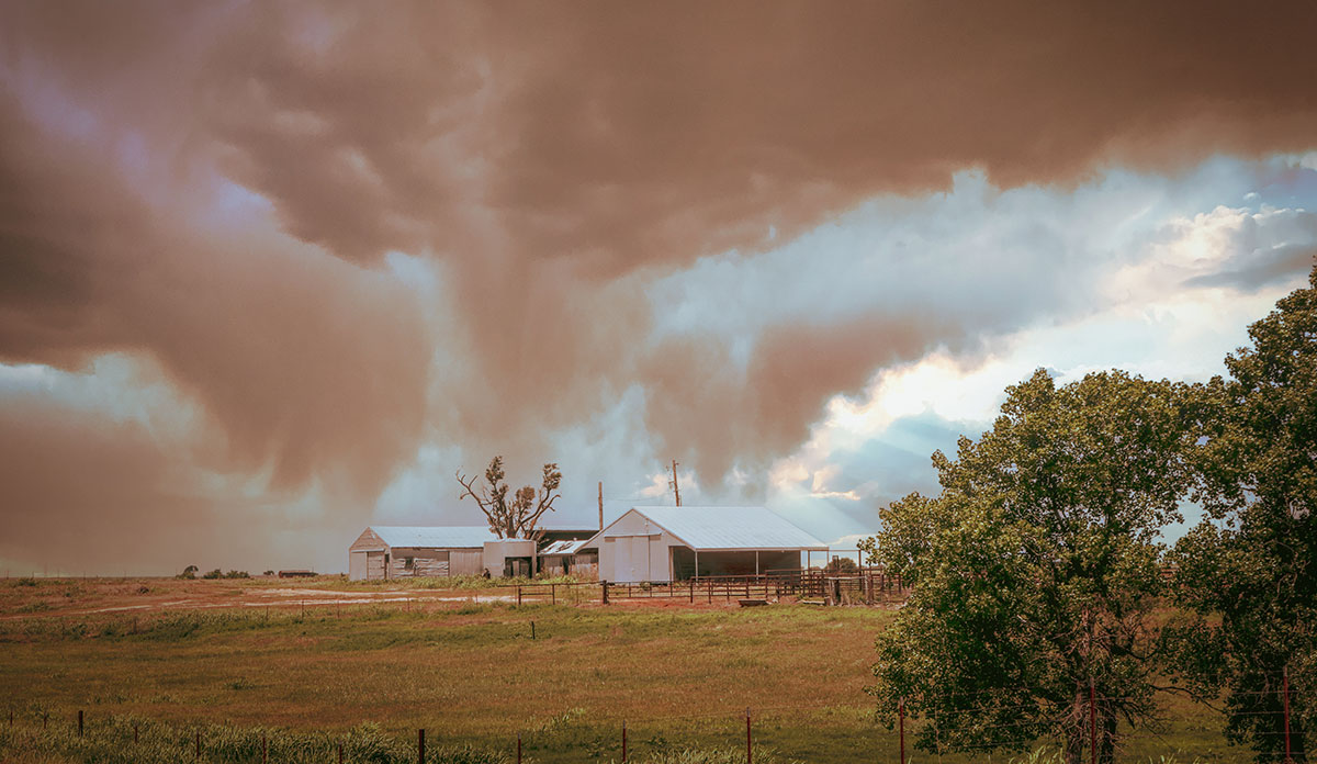 Dust cloud over farm house