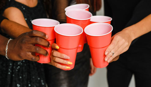 hands on red cups