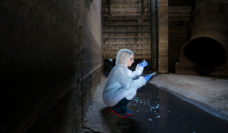 worker takes a wastewater sample