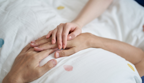 comforting patient laying in bed