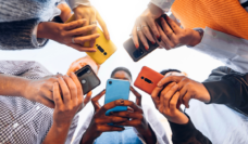 adolescents on phones in a circle